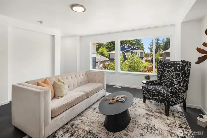 Upper-level leisure room offers a flexible second living space with abundant natural light and neighborhood views.