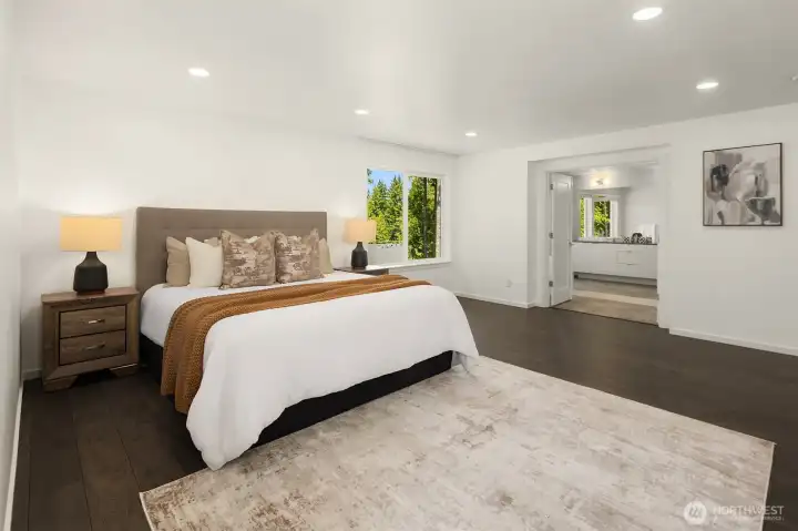 Spacious Grand Suite with wide-plank flooring, peaceful greenbelt outlooks, and direct access to the spa-inspired bath.