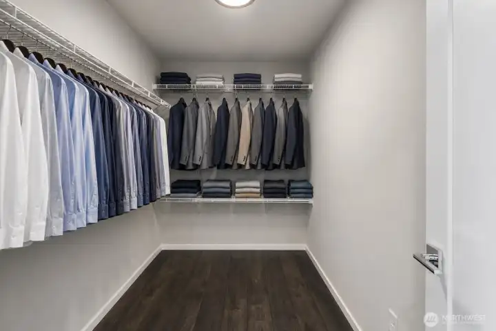 One of two spacious walk-in closets, offering generous hanging space, open shelving, and room for organized everyday storage
