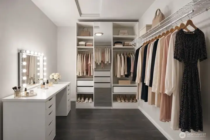 Second walk-in closet creates a boutique-style dressing area with expanded wardrobe storage, display shelving, and vanity space.
