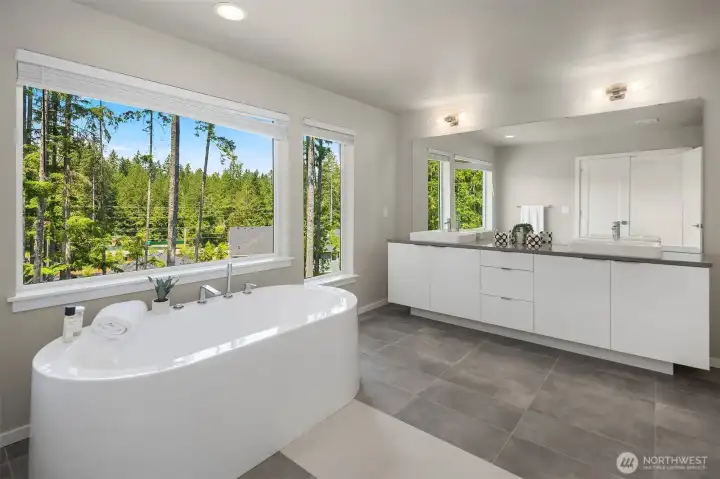 Spa-inspired primary bath features a large tiled walk-in shower and direct connection to the spacious Grand Suite.