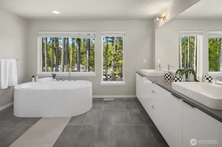 Spa-inspired primary bath with clean modern finishes, dual vanity space, soaking tub, and a calm, streamlined design connected to the Grand Suite.