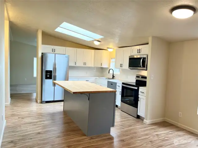 New kitchen with bright skylight & new flooring