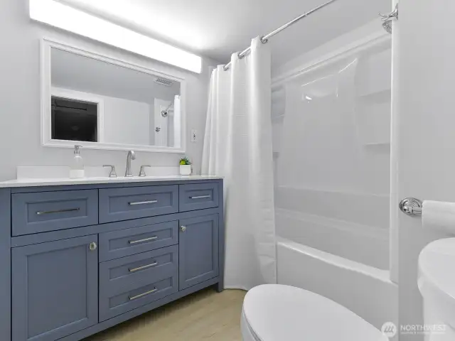 Main bathroom is all new with flooring, vanity, tub and shower, toilet