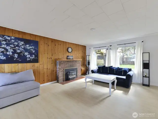 Bright, sunlit great room.. Gas insert, new paint, new floors, access to middle bedroom and sunporch
