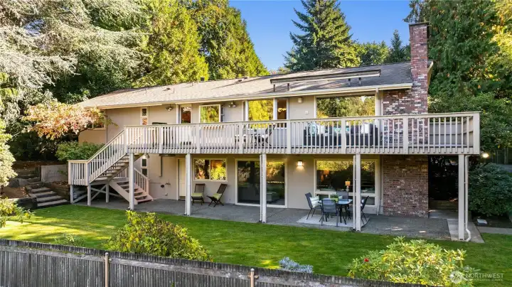 Expansive back deck and lower patio spaces overlook the private yard—perfect for outdoor entertaining and relaxed Northwest living.
