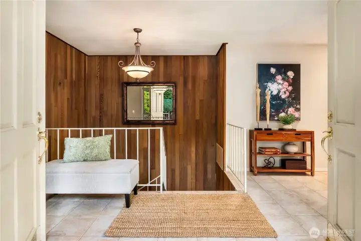 The foyer blends modern comfort with natural textures, introducing the home’s timeless aesthetic.
