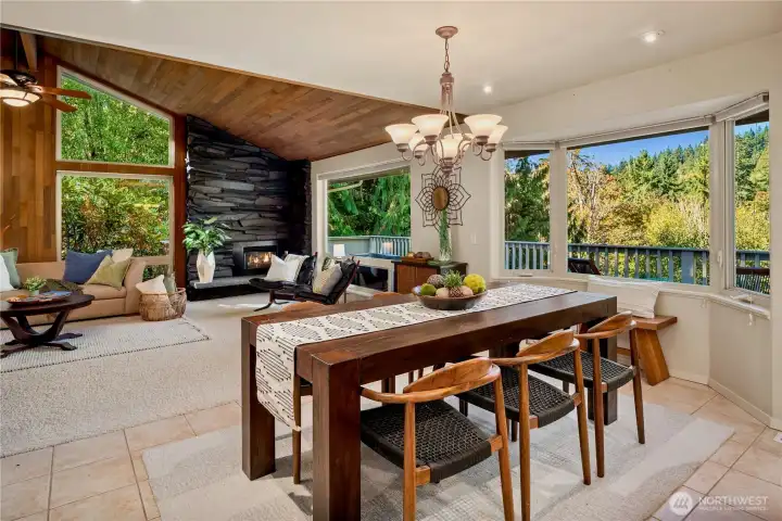The dining area enjoys panoramic views and an easy connection to the spacious deck for seamless indoor-outdoor entertaining.