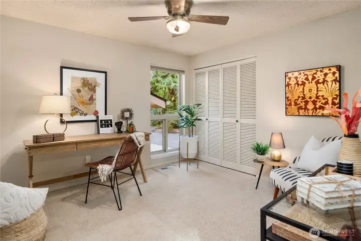Versatile third bedroom or home office on the main level, ideal for working from home or creative pursuits.