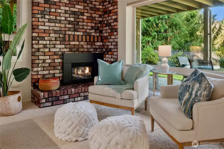Cozy fireside seating with a timeless brick hearth, the ideal spot to curl up with a book or enjoy quiet evenings.