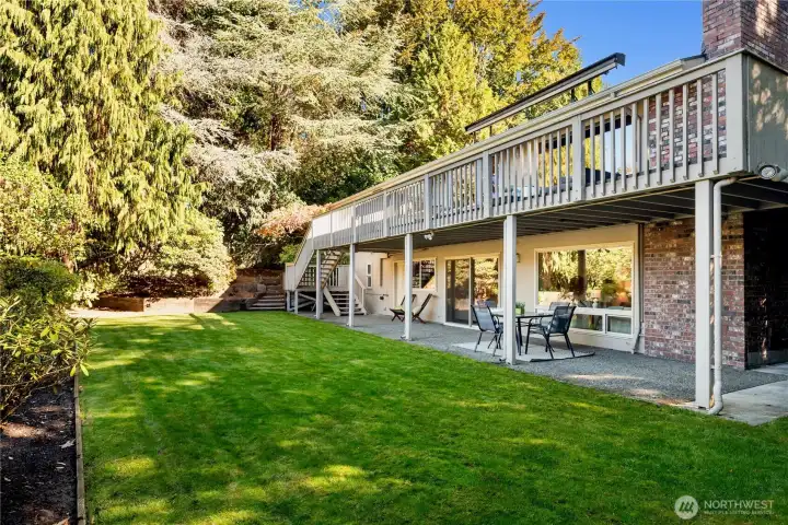 The home’s broad deck and lower patio embrace the lush backyard - an open invitation for morning coffee, good times, and long summer evenings.