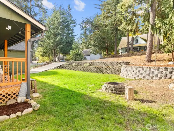 Unique front yard (offset from the road) with retaining walls, great for entertaining, gardening, or simply soaking in the peaceful PNW backdrop.