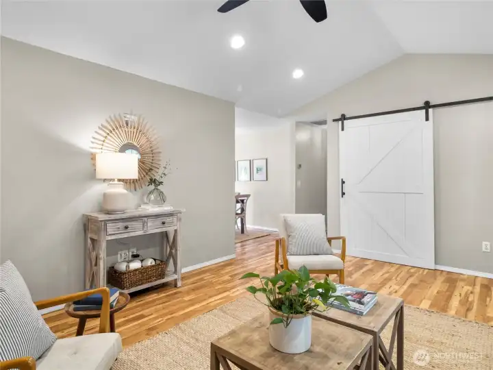 The heart of the home—featuring a cozy living area and barn door accent that adds rustic charm and convenient entry way bench/coat closet.
