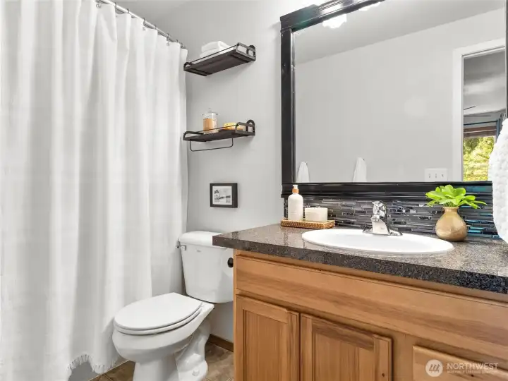 Updated primary bathroom with double vanity and stylish finishes.