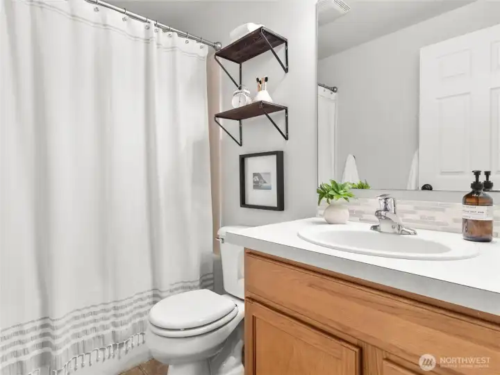 Clean, bright guest bath with updated fixtures and modern touches.