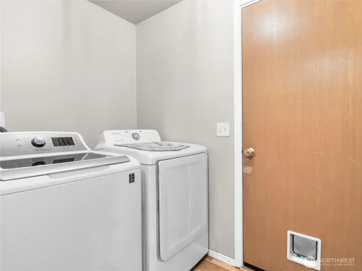 Dedicated laundry space with shelving and room for storage. Washer/Dryer stay or bring your own!