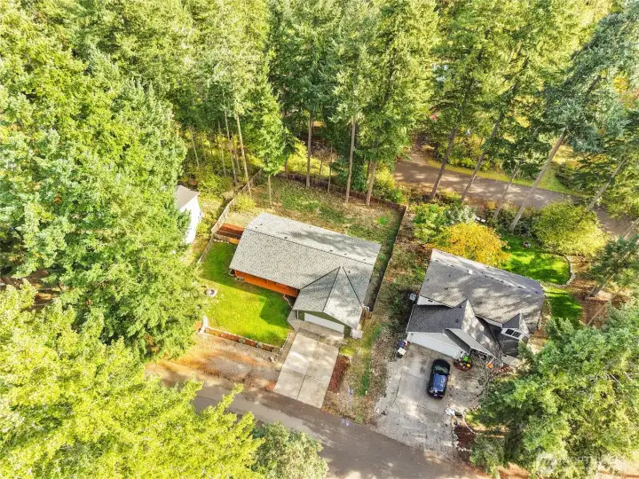 Bird’s-eye view of the property showing ample lot size and natural setting.