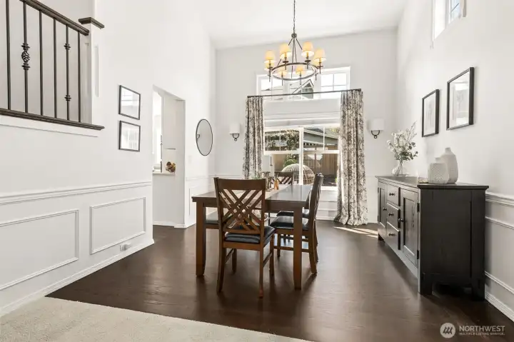The shadow box detail, impressive lighting fixture, and plethora of windows make this dining room extra special.