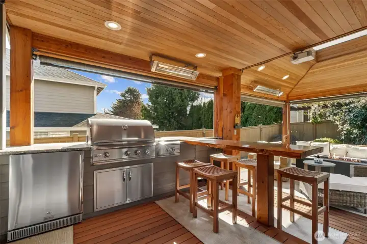 Here's a sneak peak of what's outside those French Doors! A well-appointed outdoor kitchen featuring a built-in grill, beverage refrigerator, live-edge raised bar seating for effortless entertaining! (More to follow)