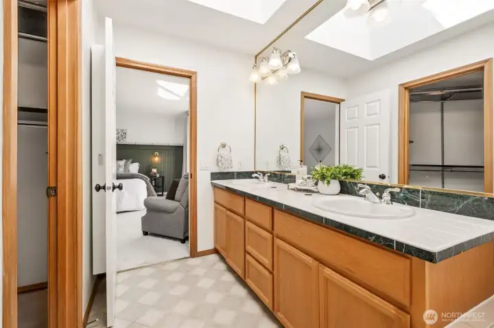 Generous 5-piece primary bath with dual sinks, relaxing soaking tub, separate shower, and great natural light.