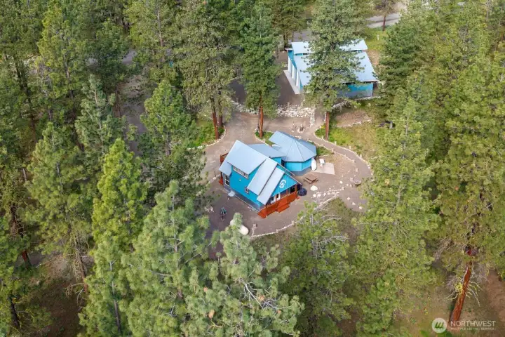 Immaculate condition of this 942 sf tiny home, 200 sf studio outbuilding & quality built 1,440 sf garage & shop all cleverly designing for comfort and ease of living full time or part time.  Well-manicured 1 Acre Lot of lightly treed property.