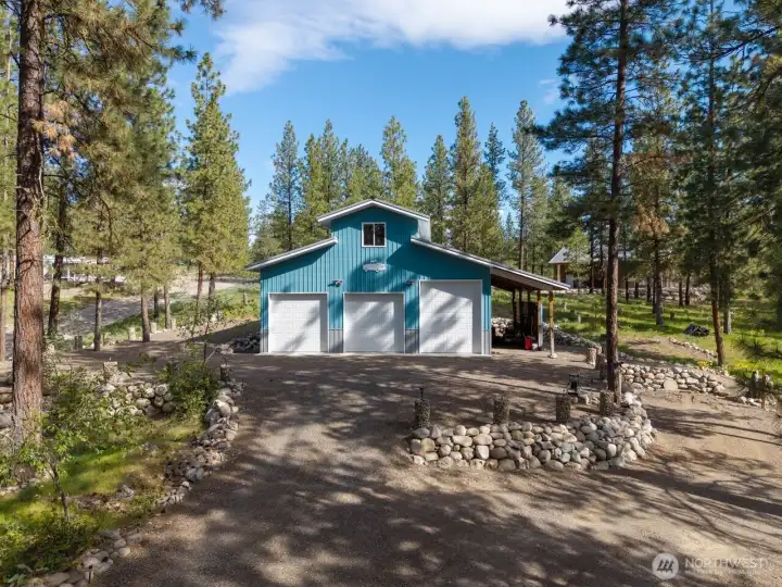 1440 sf Garage and shop is well built inside & out with an attached Lean to shed. Slab-on-grade concrete floor. Loft storage. Convenient 1/2 bath. 3 Garage doors. 2 Man doors. Shop is heated and has ample lighting throughout. Plenty of parking. Garden area.