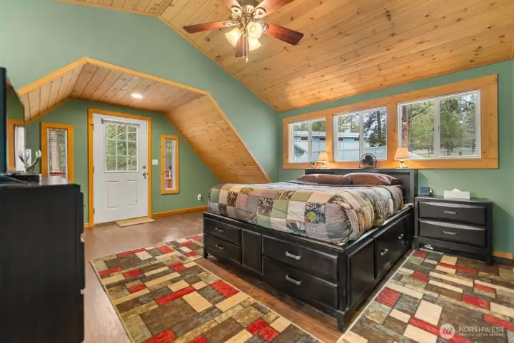 Primary bedroom has lighted fan to keep you cool. Beautiful Pine ceiling.