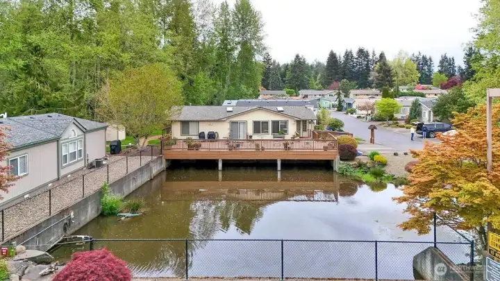 A view of club house with large deck overlooking the beautiful pond.