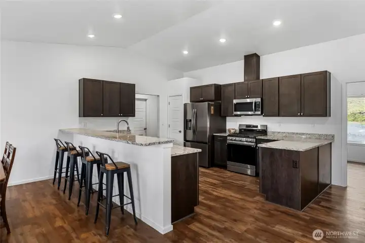 Granite counter, stainless appliances, 2 lazy susan's, pullout drawers, soft close cabinets and eating bar for 6! Pantry closet too...