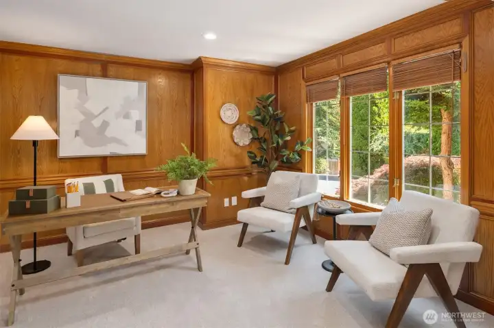 Main floor office with beautiful wood paneling and French doors for privacy.