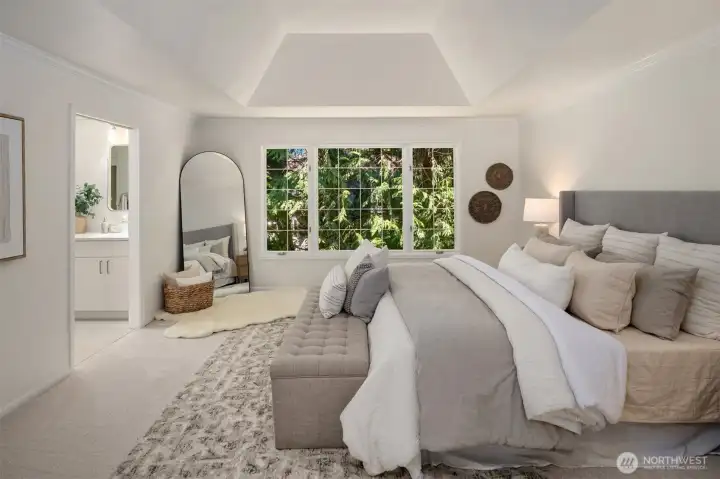 Huge primary suite with evergreen views.