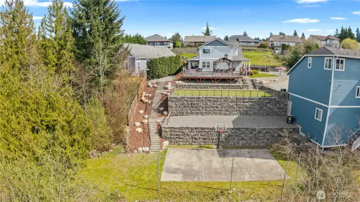 Amazing Terraced Yard was just completed with multiple levels and an insanely superb engineered staircase. You have your View and Entertainment Deck, then the large Turfed Yard, then the Gravel Space which could hold your firepit and chairs and then your Sport Court. So much space for so much fun! The Side Sewer was also re-engineered and relocated alongside the stairs in order to work more effectively with the slope.