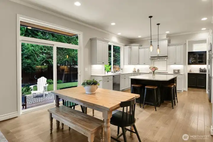 Kitchen w/informal eating nook and eating bar at kitchen island. Lovely outlook to back yard. Kitchen w/informal eating nook and eating bar at kitchen island. Lovely outlook to back yard.