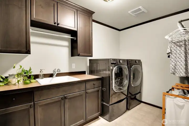 Bedroom level laundry with utility sink and built in cabinetry Bedroom level laundry with utility sink and built in cabinetry