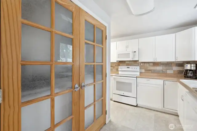 Laundry behind double doors.