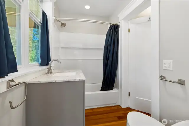 Jack and Jill Full Bathroom connecting living space to laundry room.