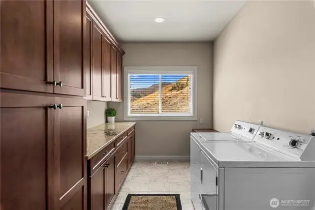 Laundry with natural light, abundant storage and counter space.