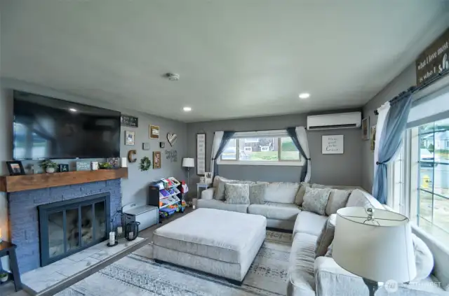 Cozy living room with room for ample seating and fireplace.