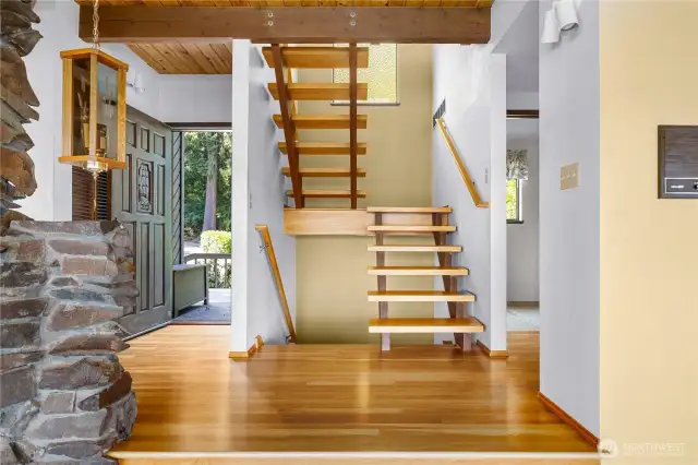 Looking back toward the front door and mid-century modern stairs to upper and lower levels.