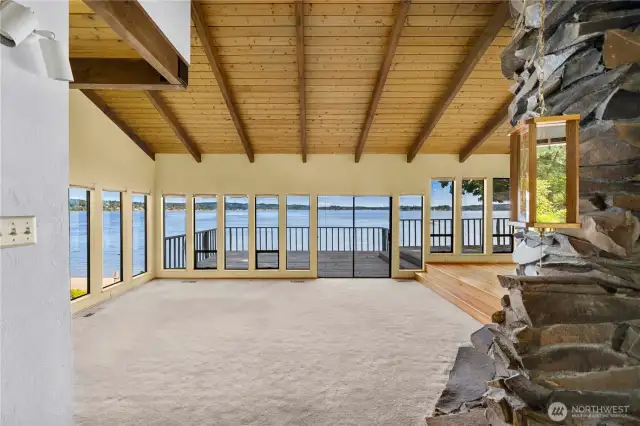 Walls of windows, pine ceilings with beams are showcased thru-out the home. Newer hardwood floors in the entry, dining, and kitchen.