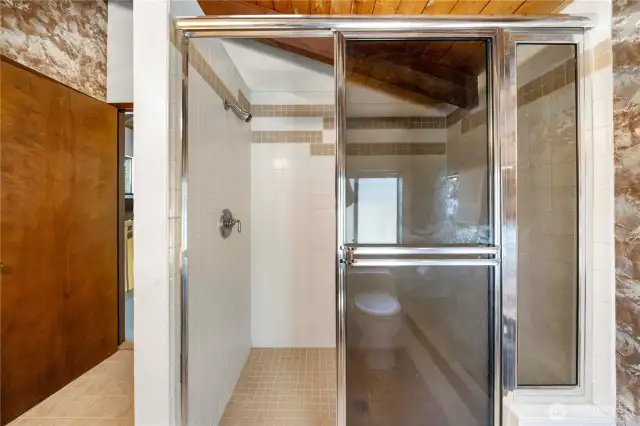 Large tiled shower in the primary bathroom.