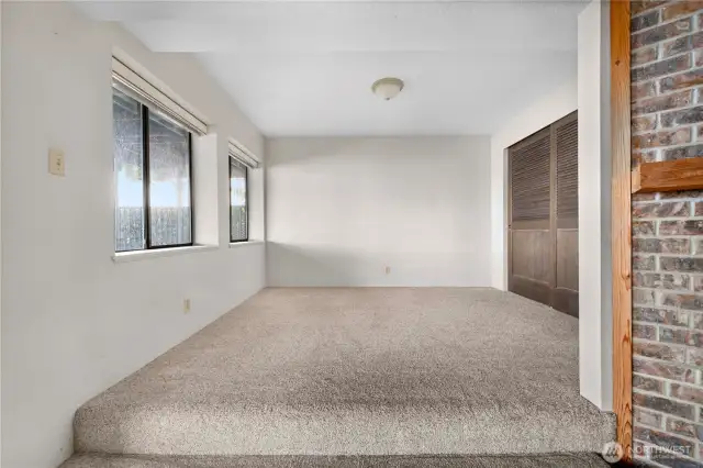 This space could easily convert into a bedroom - it already has a wall of closets.