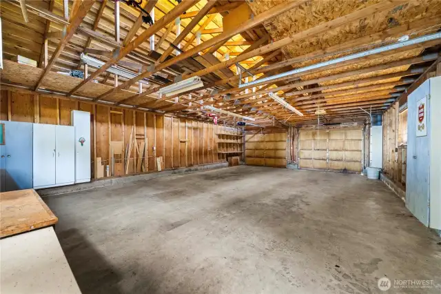 4-car garage has storage units and workshop area.