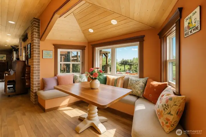 A bright and inviting breakfast nook with natural light and cozy seating, perfect for casual meals or morning coffee while overlooking the surrounding views.