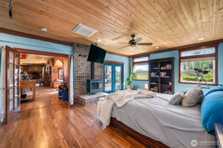 Primary suite with gas fireplace, spa-like bath, and serene garden views.