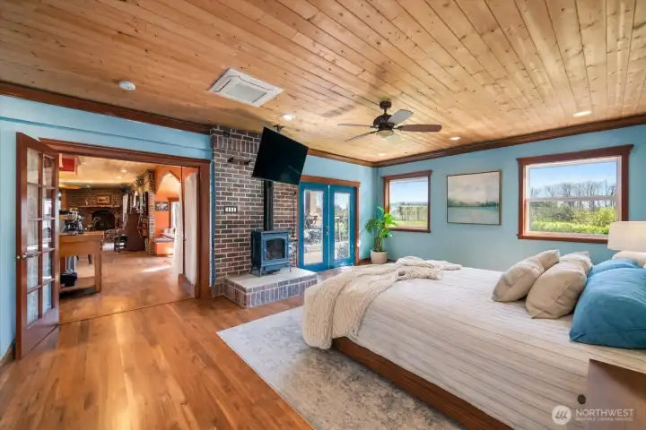 Primary suite with gas fireplace, spa-like bath, and serene garden views.
