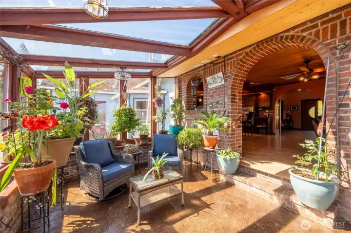 Copper penny–tiled sunroom blending indoors with the gardens outside.