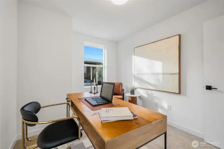 One of the two lower level bedrooms, staged as an office.   Photos are of model home of similar floorplan. Color scheme and layout will vary.