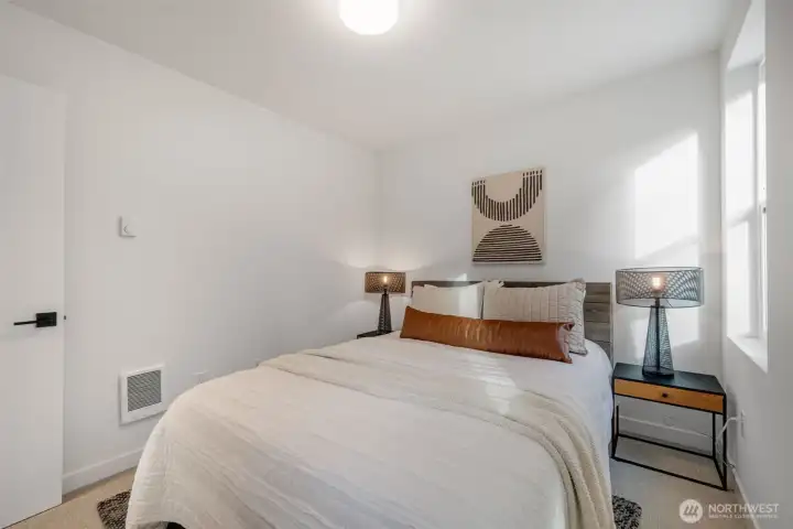 The second of two lower level bedrooms.   Photos are of model home of similar floorplan. Color scheme and layout will vary.