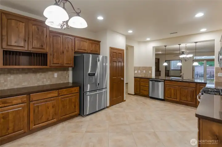 Upgraded cabinetry including this custom built-in hutch.  Solid surface Sile stone counter tops.  This kitchen has loads of counter top space.